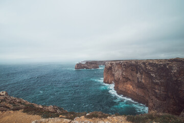 Cape Cabo de Sao Vicente in the southwest of Portugal in the Algarve region. Watching the rocky cliffs. Wandering of Fisherman Trail