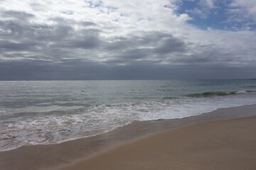 panorama of the shore line in southern Portugal with storm clouds in the distance 
