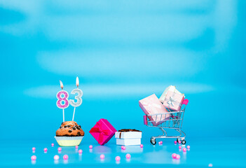 Creative card Happy birthday background for a girl or woman with a number of candles in a muffin...