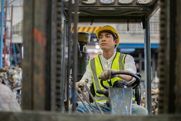 Man wear safety helmet driver forklift warehouse in factory. Male worker industrial operate....