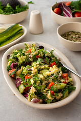 Healthy lunches, millet porridge or quinoa with mixed salad, tomatoes and cucumbers with parsley and pumpkin seeds, healthy food