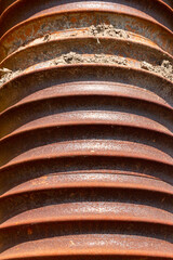 A close up view of rusted old coil.