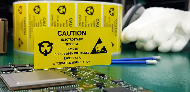 The yellow CAUTION label for Electrostatic Sensitive Devices (ESD) on static free workstation.