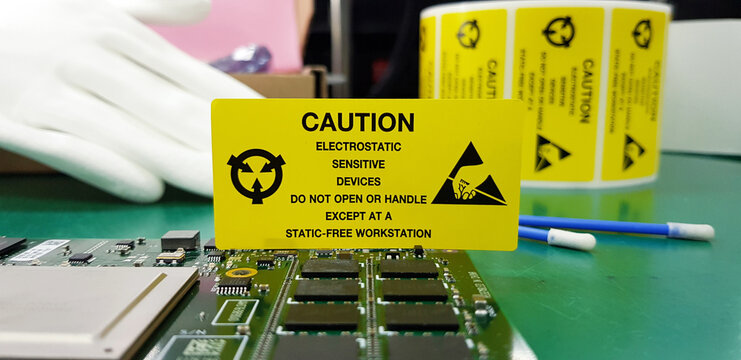 The yellow CAUTION label for Electrostatic Sensitive Devices (ESD) on static free workstation.