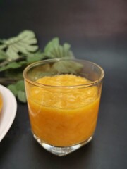 Mango smoothie on black background