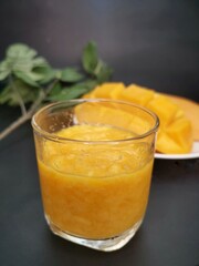 Mango smoothie on black background
