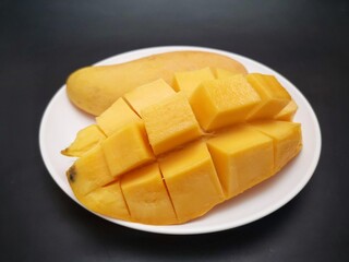 Mango tropical fruit on black background