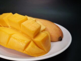 Mango tropical fruit on black background