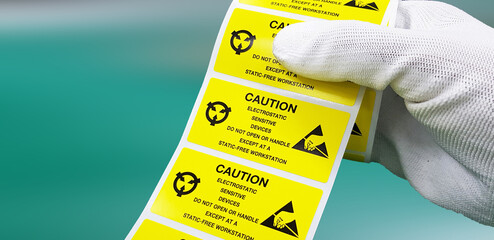 Hand holding ESD symbol label with antistatic gloves,Electrostatic Sensitive Devices (ESD) in...