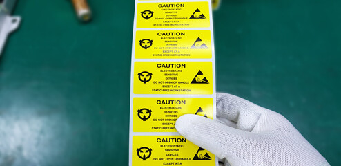 Hand holding ESD symbol label with antistatic gloves,Electrostatic Sensitive Devices (ESD) in...