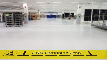 On a floor of the electronics manufacturing covered industrial linoleum pastes a yellow tape with a...