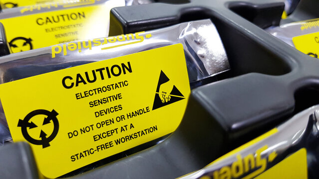 Yellow caution label on ESD bag,Standard caution label with text "Caution" for Electrostatic Sensitive Devices (ESD) in electronic industrial,Special label symbol for electrostatic sensitive devices