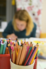 Pencils in a glass, in a creative drawing studio