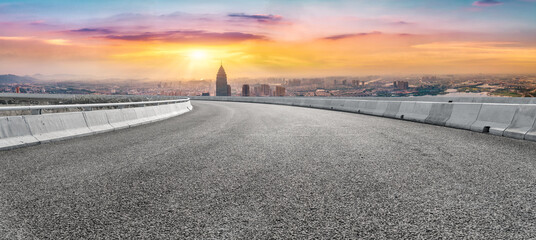 Asphalt pavement and urban building skyline