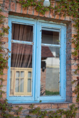 Fototapeta na wymiar Old blue window and red brick wall