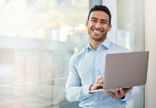 Businessman, Smile Portrait And Laptop At Office Window With Internet Connection And Career Pride. Happy Asian Male Entrepreneur With Technology, Internet And Space For Networking, Email And Work