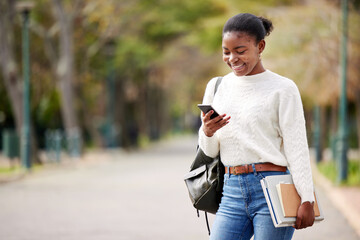 Phone, books and mockup with a student black woman on her commute to university campus for education. Mobile, social media and schedule with a female college pupil checking for her next lecture