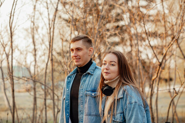 Fototapeta premium A couple in motion walks in the park in spring or autumn, happy lifestyle concept