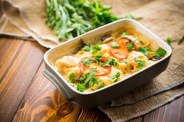 cauliflower baked with chicken fillet and mushrooms under cheese in a ceramic form