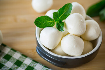 Small balls of traditional mozzarella in a ceramic bowl
