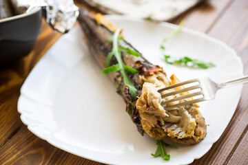 Baked fish with seasonings and spices in a plate