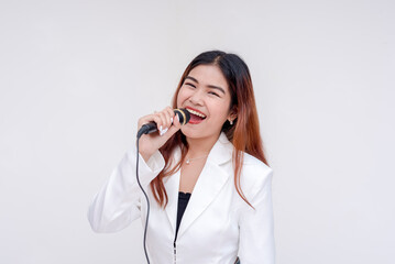 A cheerful young woman mouth wide open into a microphone while looking at the camera. Isolated on a white background.