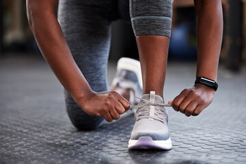 Hands, shoelaces or shoes at gym with woman, fitness or starting workout, wellness or training....