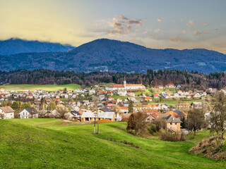 Fototapeta na wymiar Kamnik village houses and church tower with colorful sunset, Kamnik, Slovenia