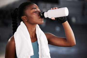 Relax, fitness or black woman drinking water in gym after training, workout or exercise to hydrate her body. Fatigue, wellness or tired girl with bottle for healthy liquid hydration on resting break