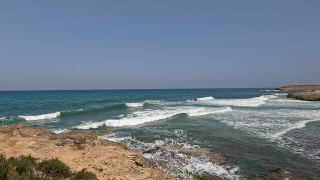 A high angle view on a wild beach  in Israel. The footage shows the sandy coast of Atlit city by the Mediterranean Sea.