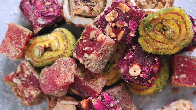 Concept of traditional cuisine and local dishes. Oriental sweets. Turkish delight rotate on a gray background