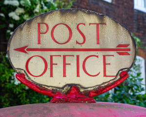 Viintage Post Office Sign on a Red Post Box in London, UK