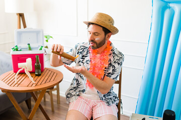 Attractive man in his 40s using sunscreen to sunbathe during vacations