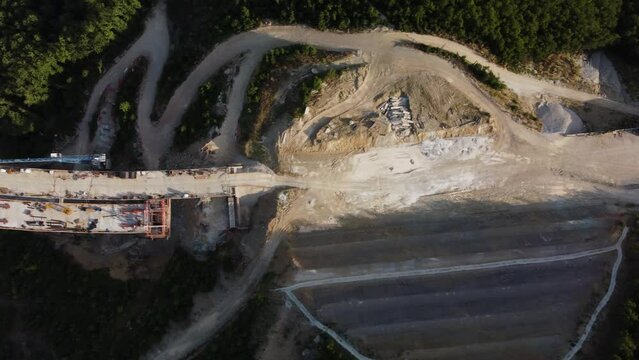 Highway bridge under construction. Aerial view of nes road. Freeway being built on a mountain terrain..