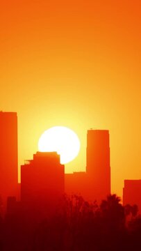 Time Lapse of the sun rising from behind the buildings of downtown Los Angeles