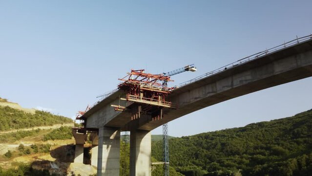 Highway bridge under construction. Aerial view of nes road. Freeway being built on a mountain terrain..