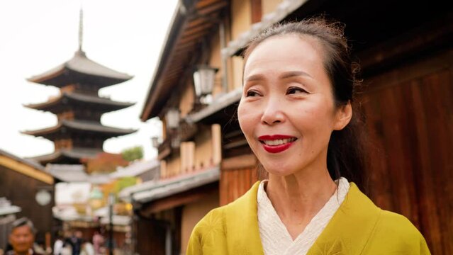 Elegant Japanese woman wearing a Kimono in the Nineizaka area of Kyoto Japan.