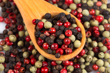 Pepper seasoning mix in wooden spoon