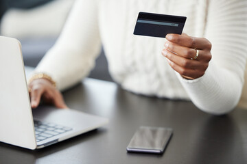 Woman, hands and laptop with credit card for payment, online shopping or finance on office desk. Hand of female person or shopper on computer for banking app, purchase or ecommerce at the workplace