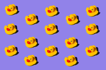 Yellow duck toy on a colored background