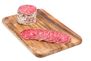 Slices of salami on wooden board