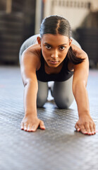 Portrait, fitness or woman stretching spine in gym preparation for exercise, workout or wellness. Face of girl, warm up or flexible Indian athlete exercising for mobility training or back flexibility