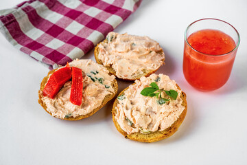 Three sliced bread with salmon spred with fresh cheese,juice,cloth.