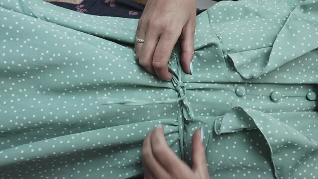 A woman unpacks the purchased goods. Trying on a summer dress. Purchase overview. vertical video.