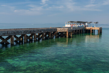 Ko Man Nai port with tourist ship on turquoise sea, Rayong