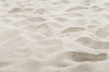 Fine Sand texture natural surface. Close up of sand on shore sea, white waves dunes, beige neutral color, minimal nature aesthetics wallpaper. Sandy beach for background, selective focus