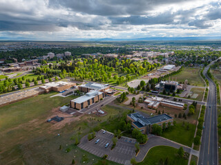 Buildings and green trees in Laramie Wyoming from aerial drone perspective