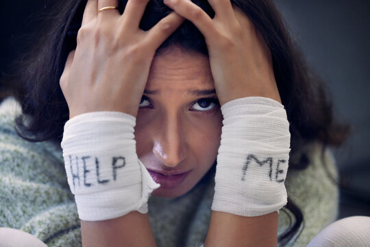 Depression, wrist and woman with help on bandage for suicide, self harm or person in dark mental health crisis. Portrait, girl and injury from depressed accident, problem or mistake in cutting wrists