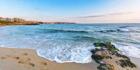 stone on the sandy sea shore. summer holiday season. travel background with clods above horizon