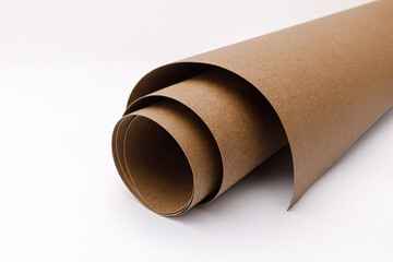 close up of rolled up brown Washable kraft paper on white background with copy space